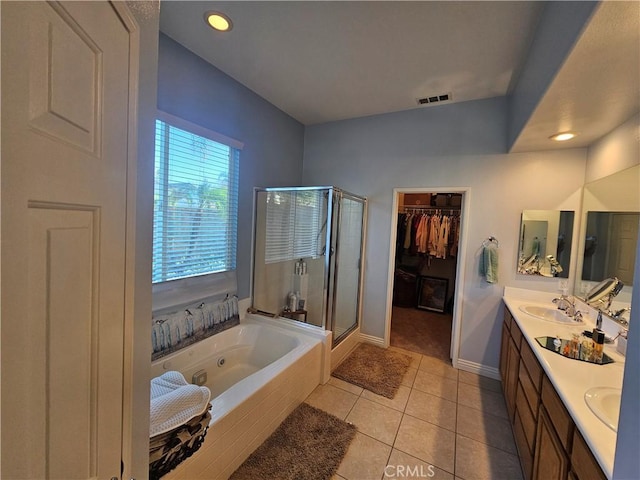 bathroom with tile patterned floors, vanity, and plus walk in shower