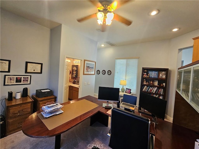 carpeted office featuring ceiling fan