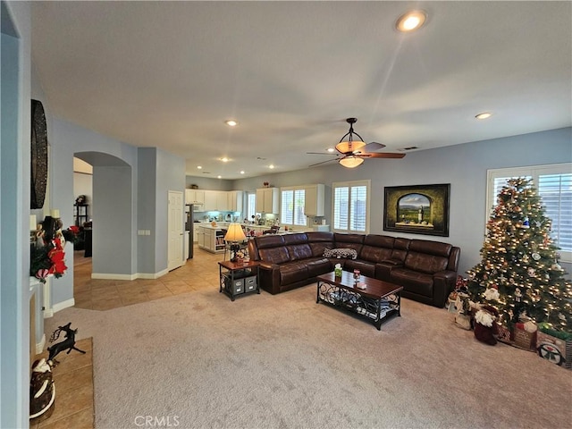 living room featuring ceiling fan and light colored carpet