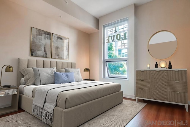 bedroom featuring wood-type flooring and multiple windows