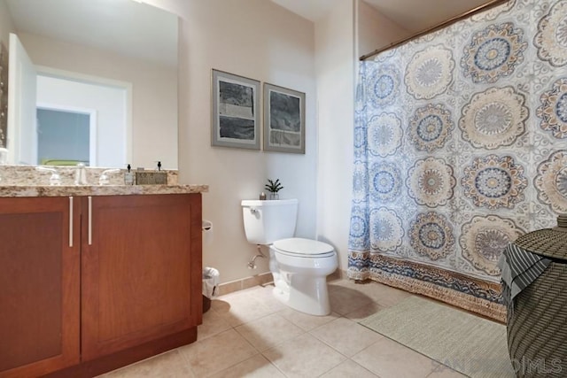 bathroom with toilet, tile patterned flooring, walk in shower, and vanity