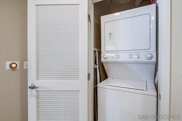 washroom featuring stacked washing maching and dryer