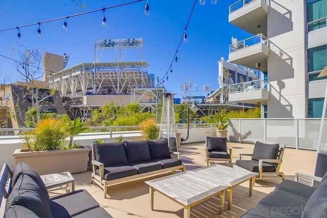 view of patio featuring an outdoor living space and a balcony