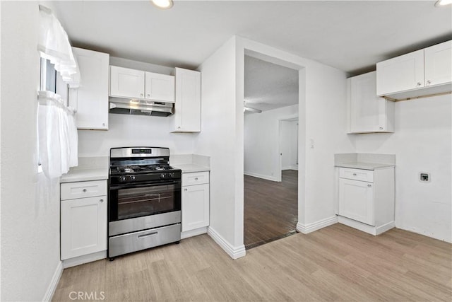 kitchen featuring light hardwood / wood-style floors, white cabinetry, and range with gas stovetop