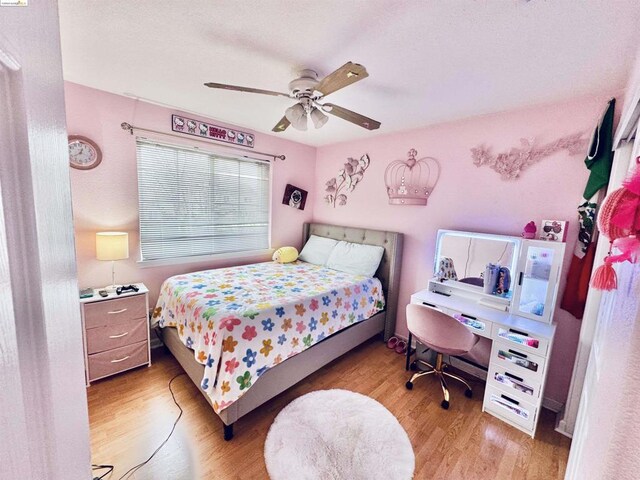 bedroom with ceiling fan and light hardwood / wood-style flooring