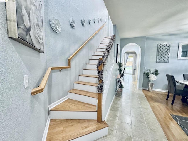 stairs featuring tile patterned flooring