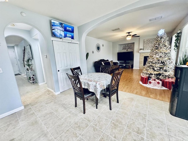 dining space featuring ceiling fan and tile patterned floors