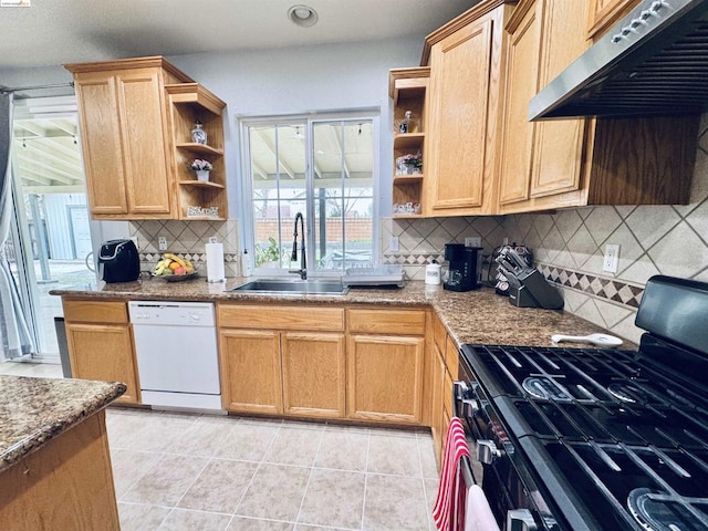 kitchen featuring extractor fan, black gas range oven, dishwasher, light stone counters, and sink