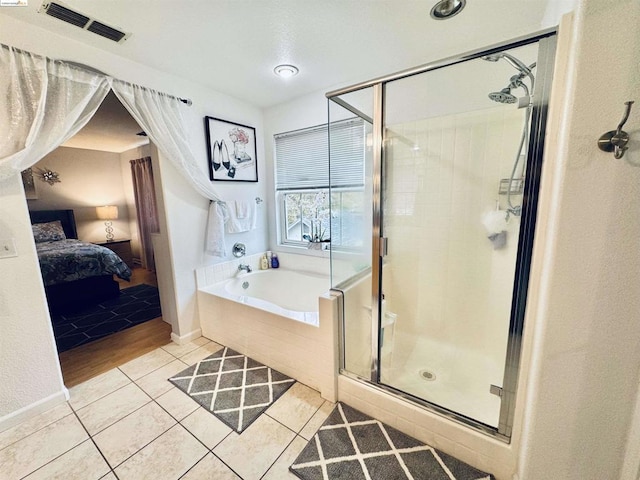 bathroom featuring independent shower and bath and tile patterned flooring