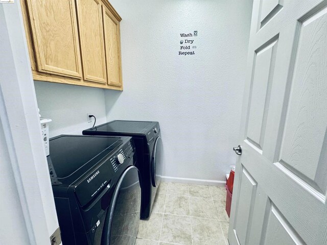 washroom featuring cabinets and separate washer and dryer