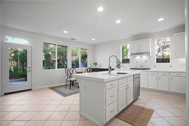 kitchen featuring dishwasher, decorative backsplash, sink, white cabinetry, and a kitchen island with sink