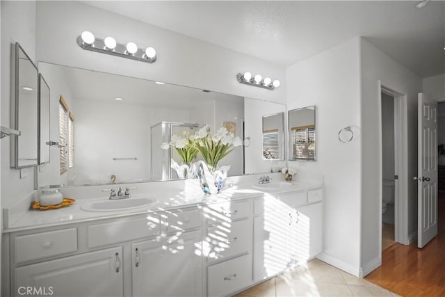 bathroom featuring toilet, tile patterned floors, and vanity