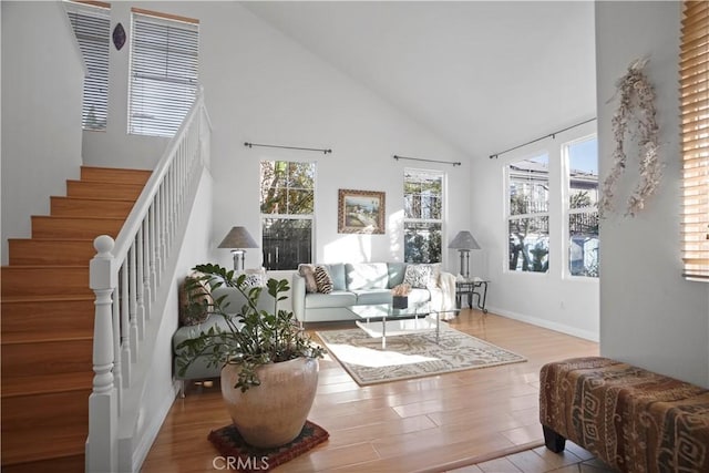 living room with a high ceiling and light hardwood / wood-style floors