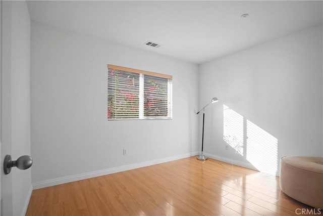 spare room with light hardwood / wood-style flooring