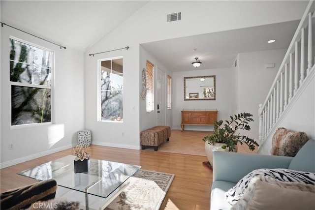 living room featuring vaulted ceiling and hardwood / wood-style flooring