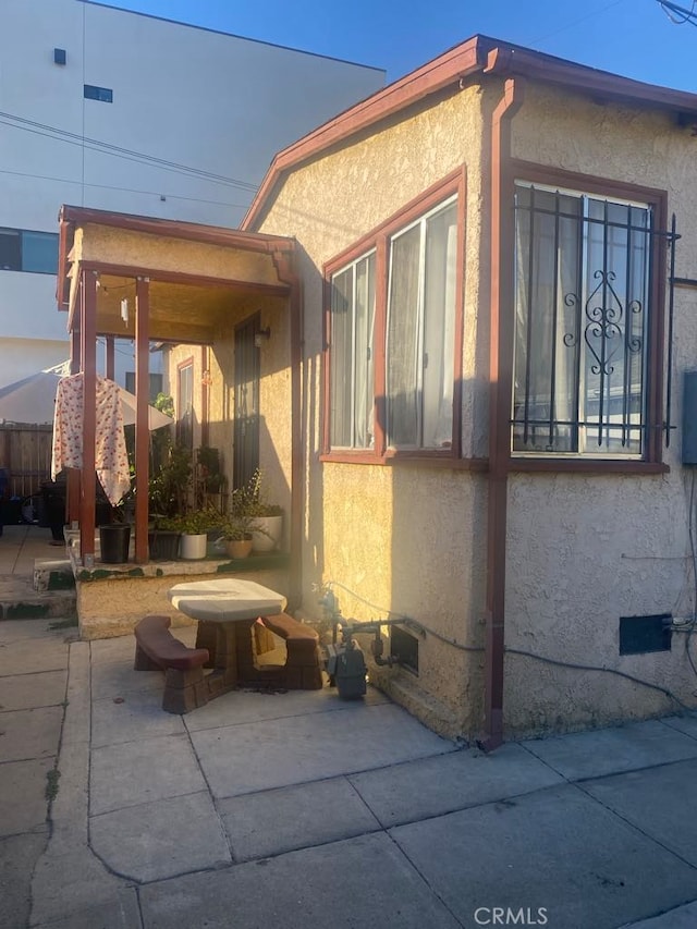 view of side of property with a patio area