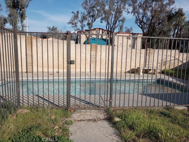 view of swimming pool featuring fence