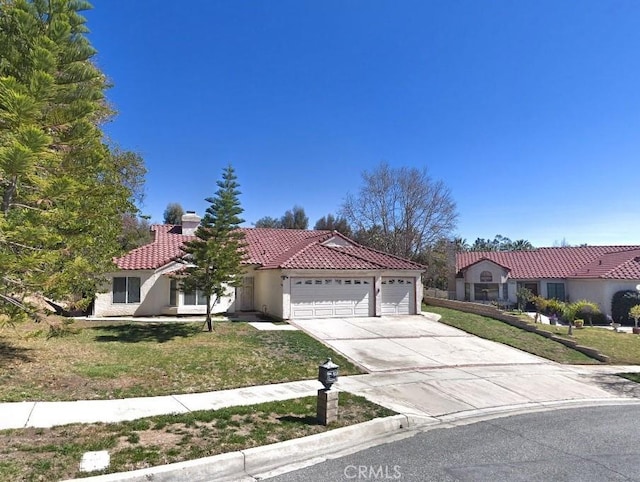 mediterranean / spanish home with a garage, a tile roof, driveway, stucco siding, and a front lawn