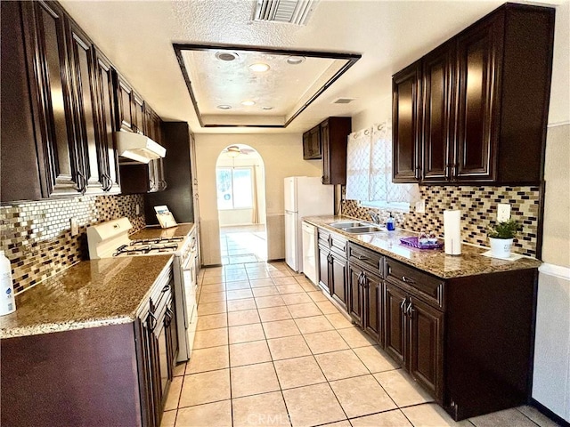 7265 Fletcher View Dr, Highland, CA 92346 - kitchen featuring white appliances, arched walkways, decorative backsplash, and range hood