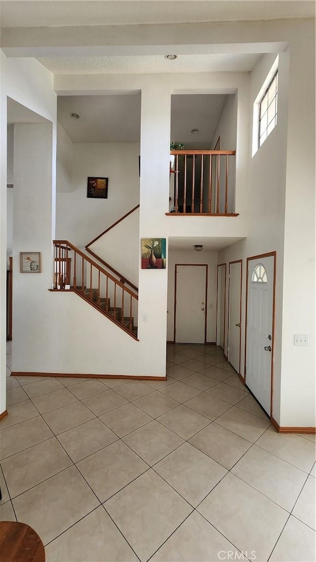 interior space featuring beam ceiling and light tile patterned floors