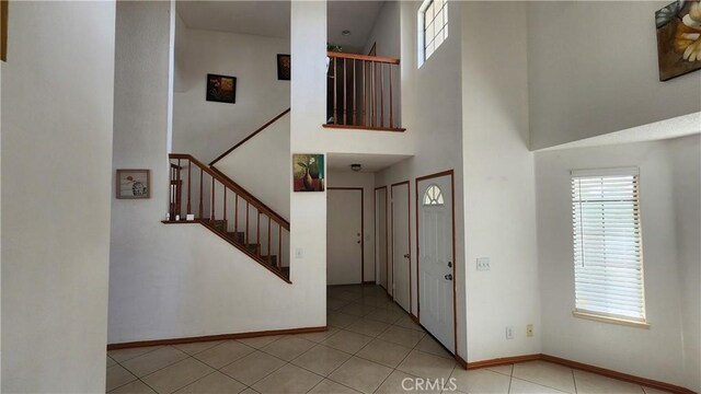 tiled entryway with a high ceiling