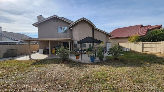 rear view of property featuring a patio area and a lawn