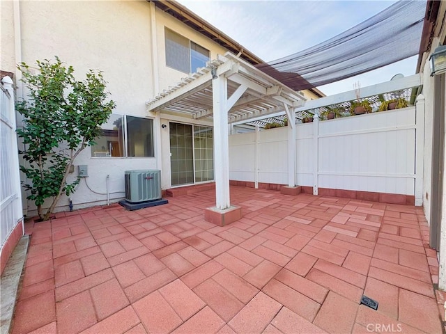 view of patio / terrace with cooling unit and a pergola