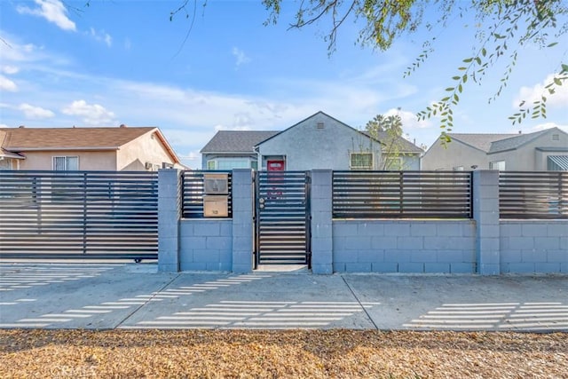 view of gate with a fenced front yard