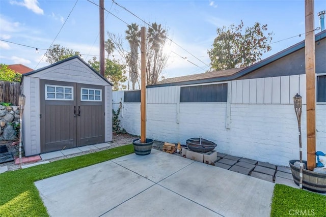 view of patio / terrace featuring a shed, an outdoor structure, and fence private yard