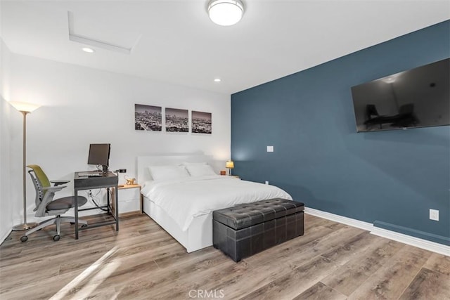 bedroom with attic access, recessed lighting, baseboards, and wood finished floors