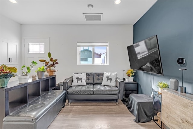 living room with light wood-style floors, recessed lighting, and visible vents