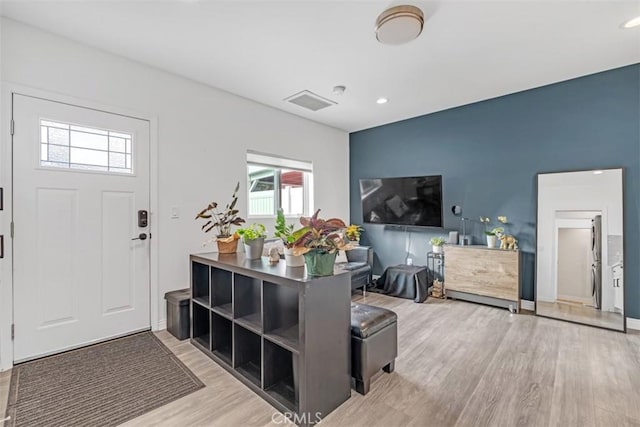 foyer featuring light wood-style floors, recessed lighting, and visible vents