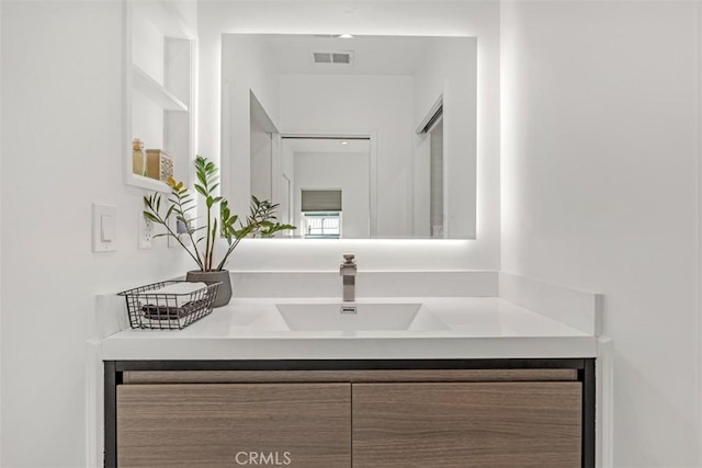 bathroom with vanity and visible vents