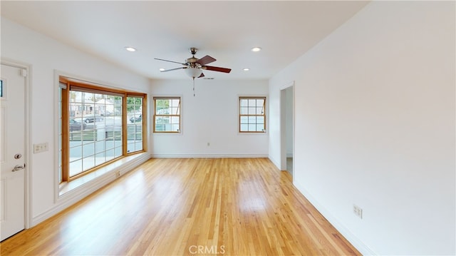 unfurnished room with light wood-type flooring, ceiling fan, baseboards, and recessed lighting