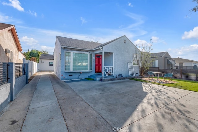 view of front of home with fence and stucco siding