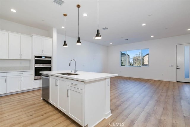 1053 Cadence, Irvine, CA 92618 - kitchen with white cabinetry, stainless steel appliances, sink, and pendant lighting