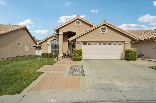 view of front of house featuring a garage and a front lawn