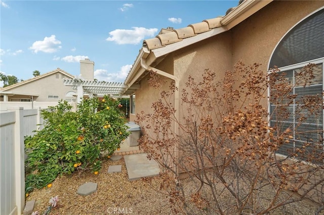 view of home's exterior featuring a pergola