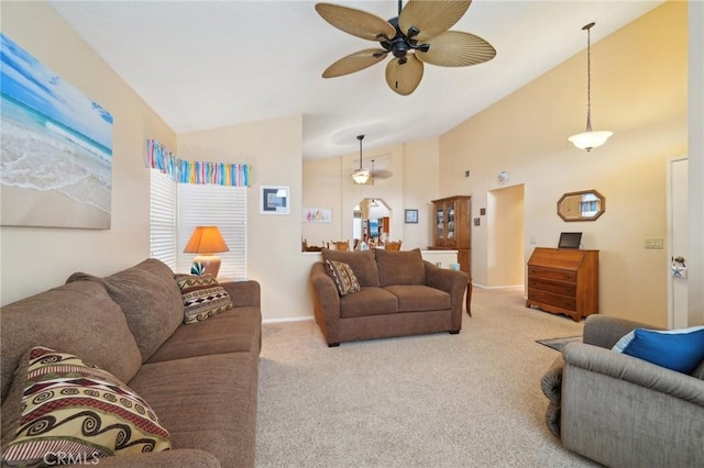 living room featuring vaulted ceiling, ceiling fan, and light carpet