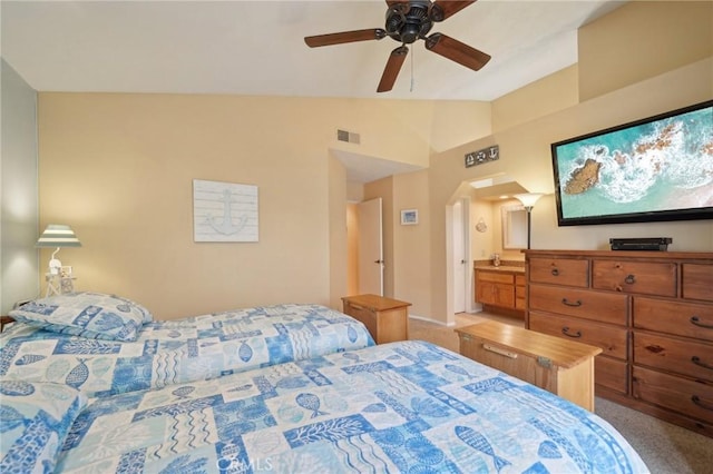 carpeted bedroom with ceiling fan, ensuite bath, and lofted ceiling