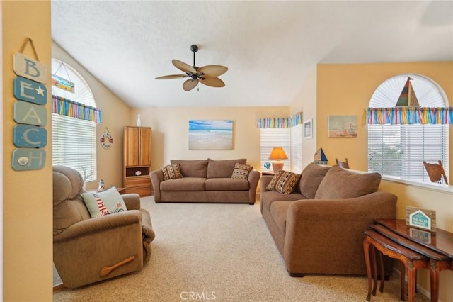 carpeted living room featuring ceiling fan and lofted ceiling