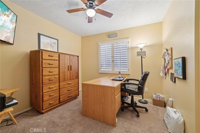 office area featuring ceiling fan, light colored carpet, and a textured ceiling