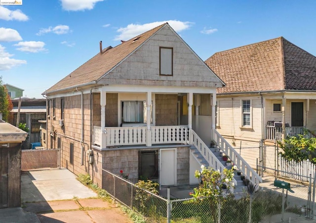 rear view of property featuring covered porch