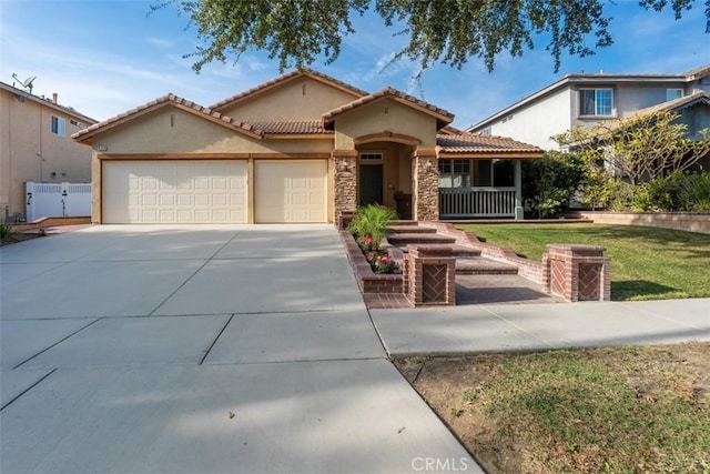 mediterranean / spanish home with a front yard and a garage