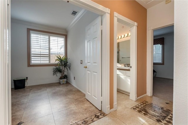 interior space featuring ornamental molding and tile patterned flooring