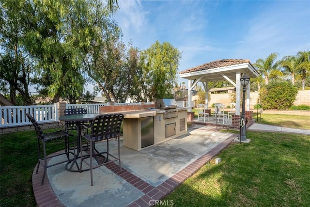 view of patio with an outdoor kitchen and grilling area