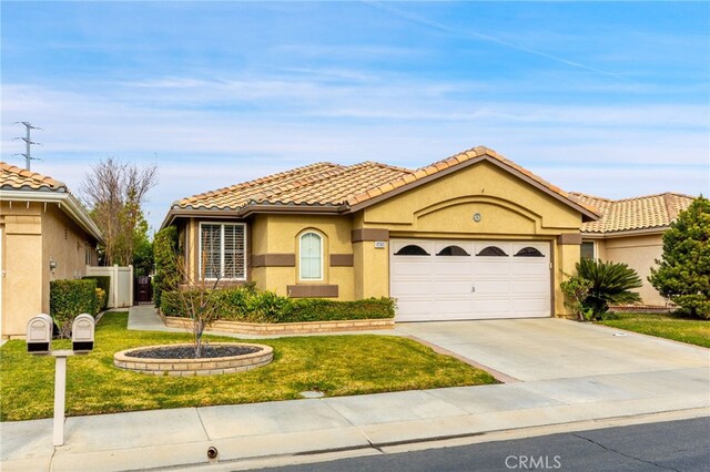 mediterranean / spanish home featuring a front lawn and a garage