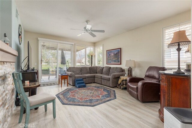 living room with ceiling fan and light hardwood / wood-style floors