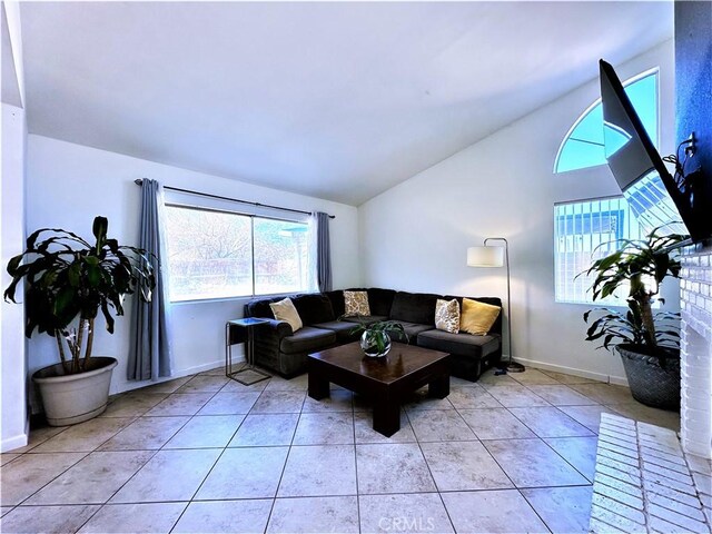 living room featuring lofted ceiling and light tile patterned floors