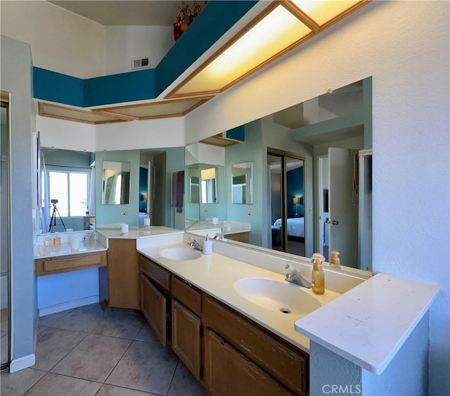 bathroom featuring a bathing tub, tile patterned floors, and vanity